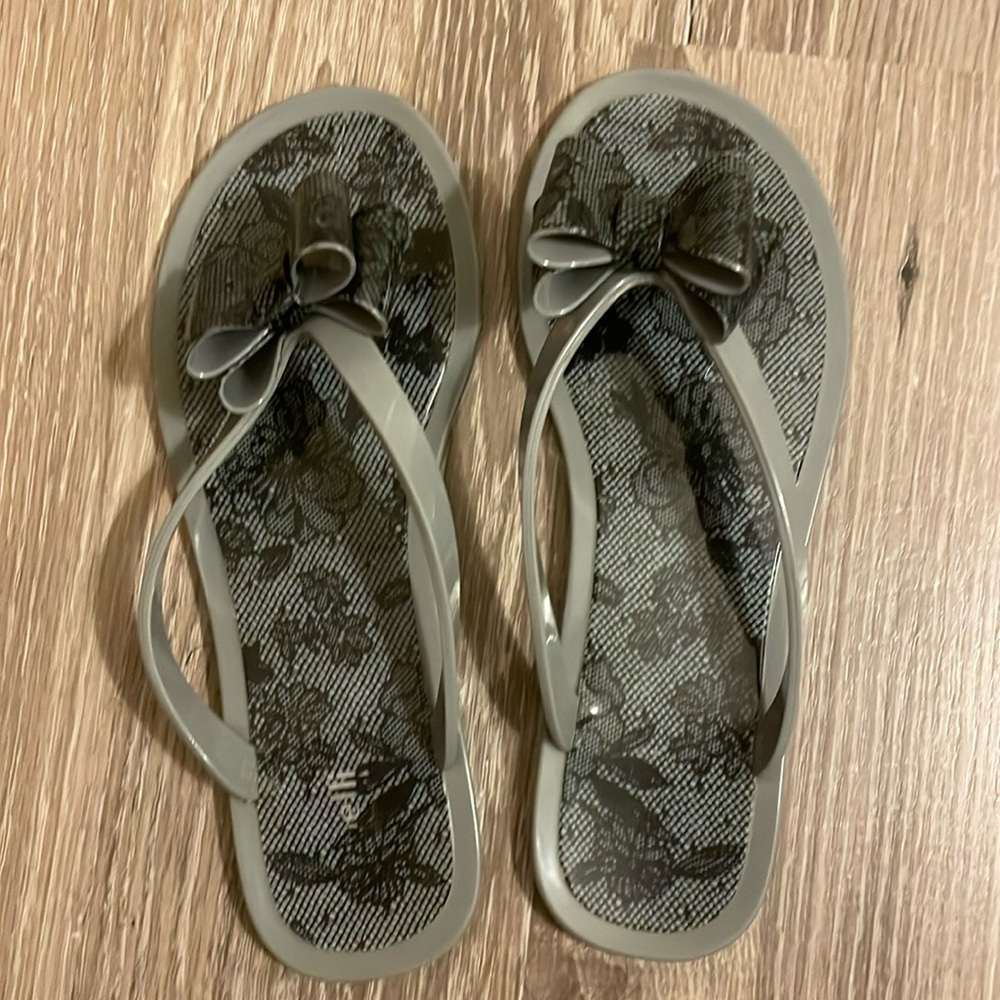 Grey and black bow flip flops